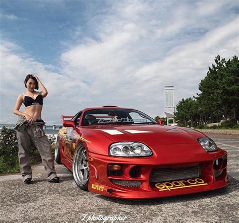 Girl rides in Drifting Toyota Supra .